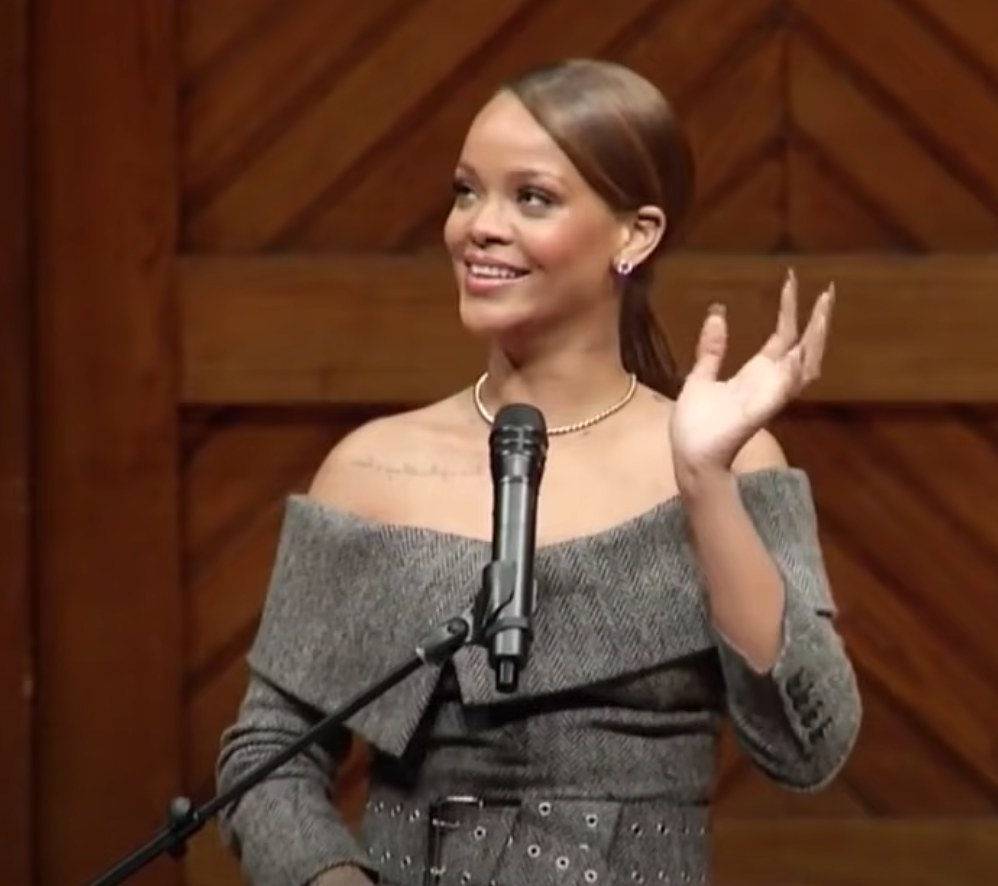 Rihanna waves to the crowd as she gives a speech at Harvard University