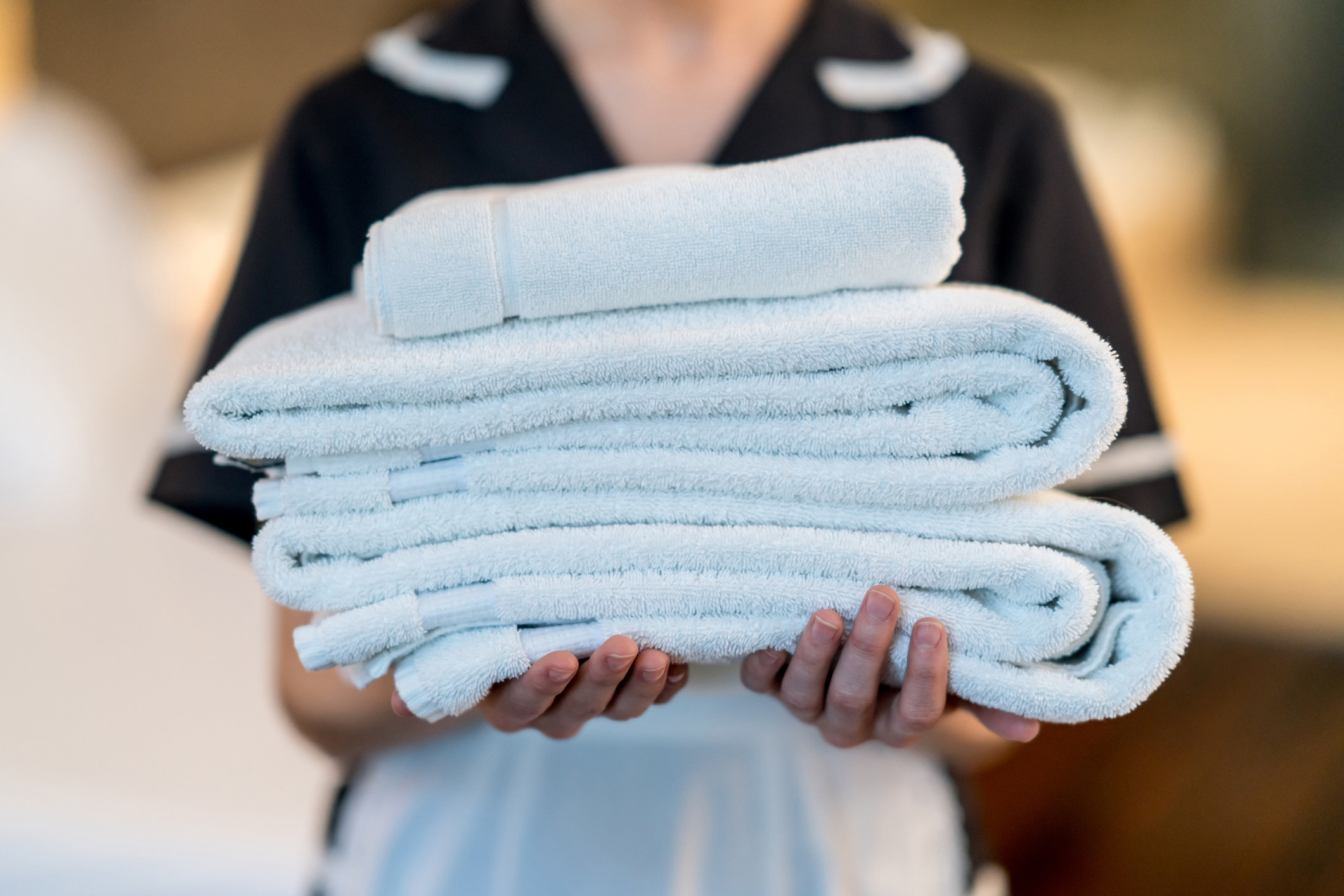 A maid holding clean towels