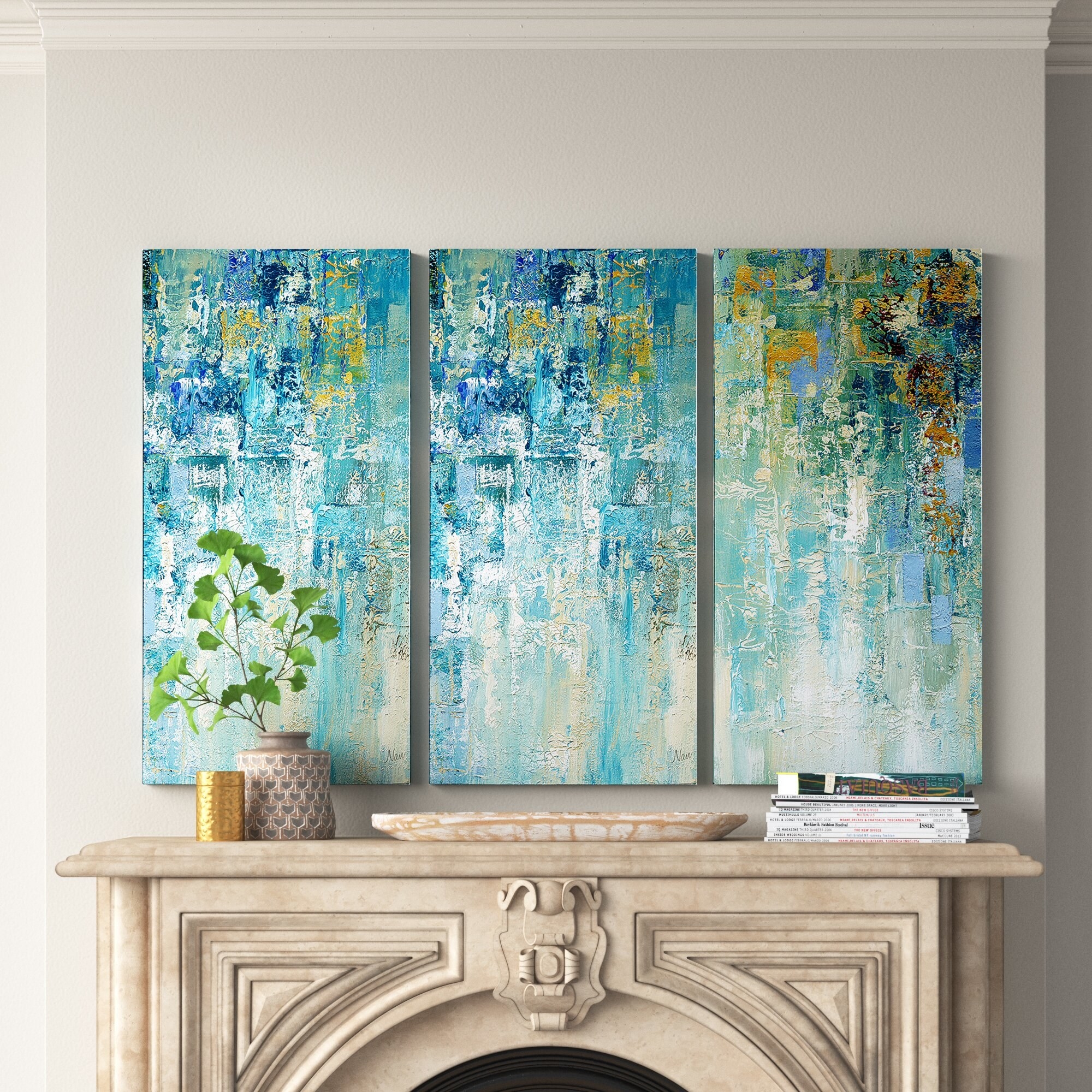 watercolor blue and yellow art triptych above antique-looking white fireplace mantle