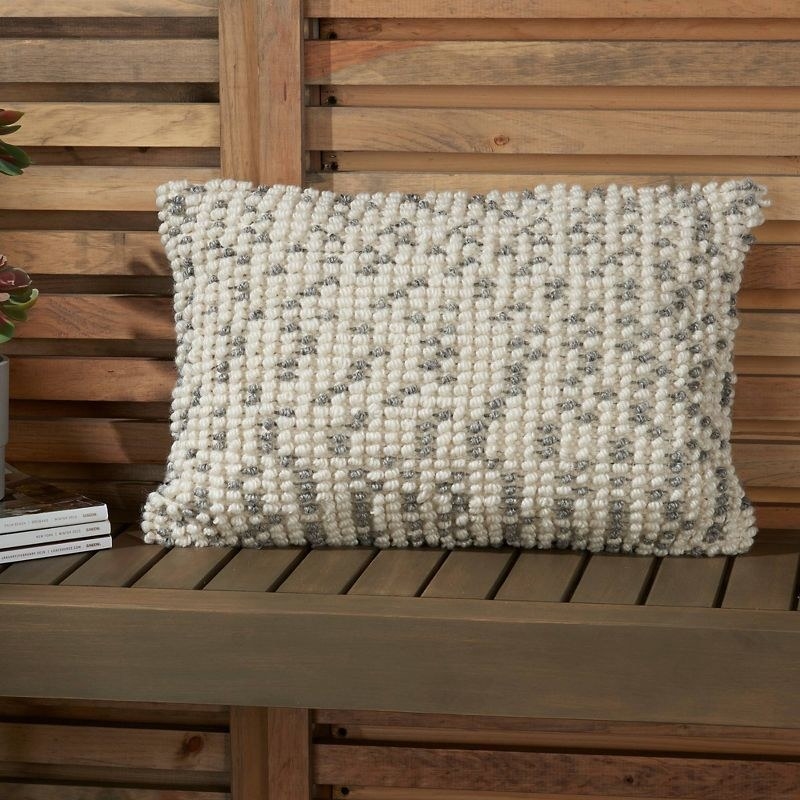 a pillow on a wooden bench