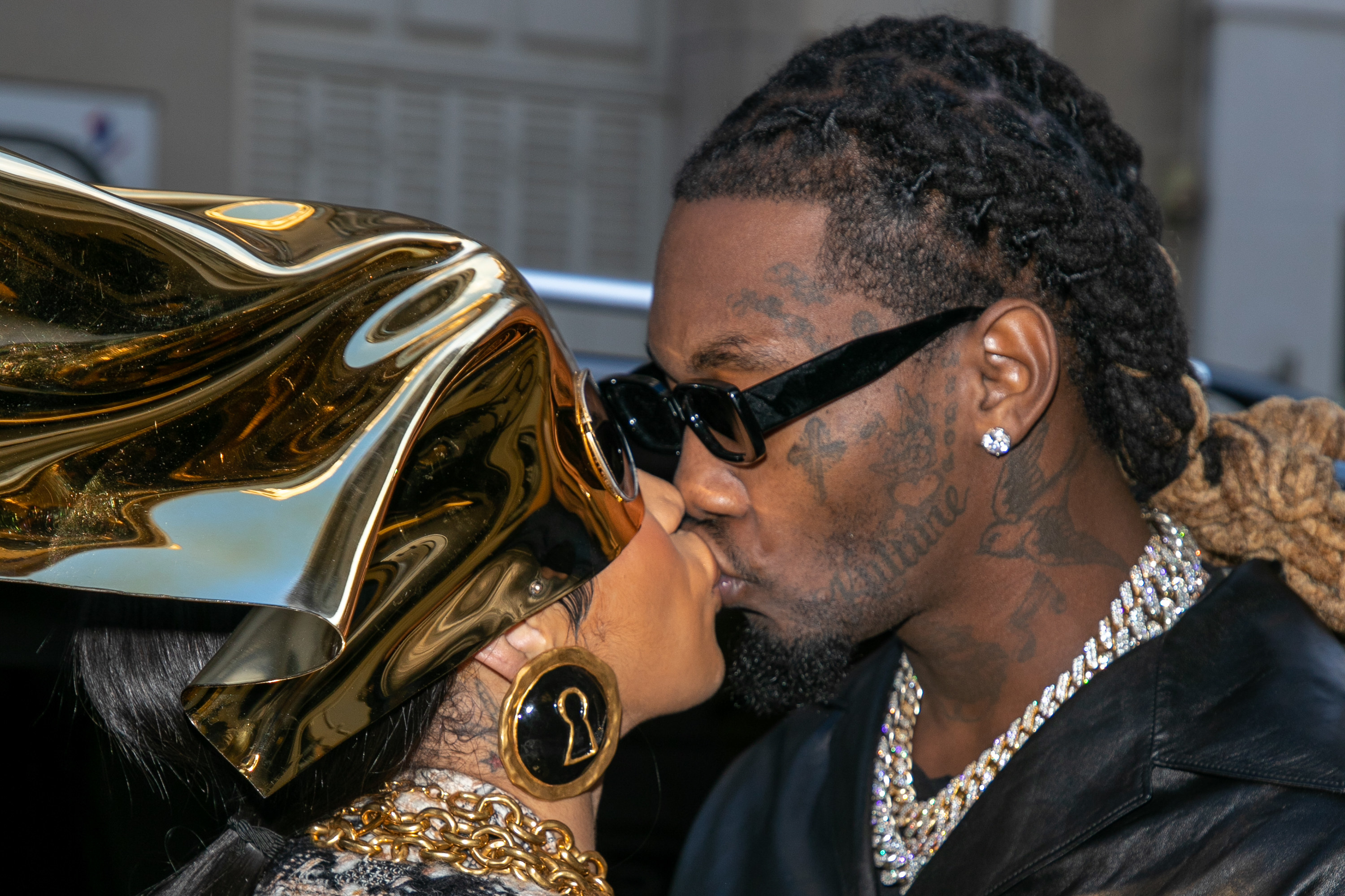 Cardi B and Offset kissing at an event