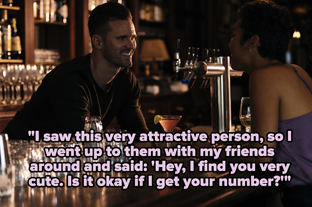 A man and a woman talking at a dimly lit bar