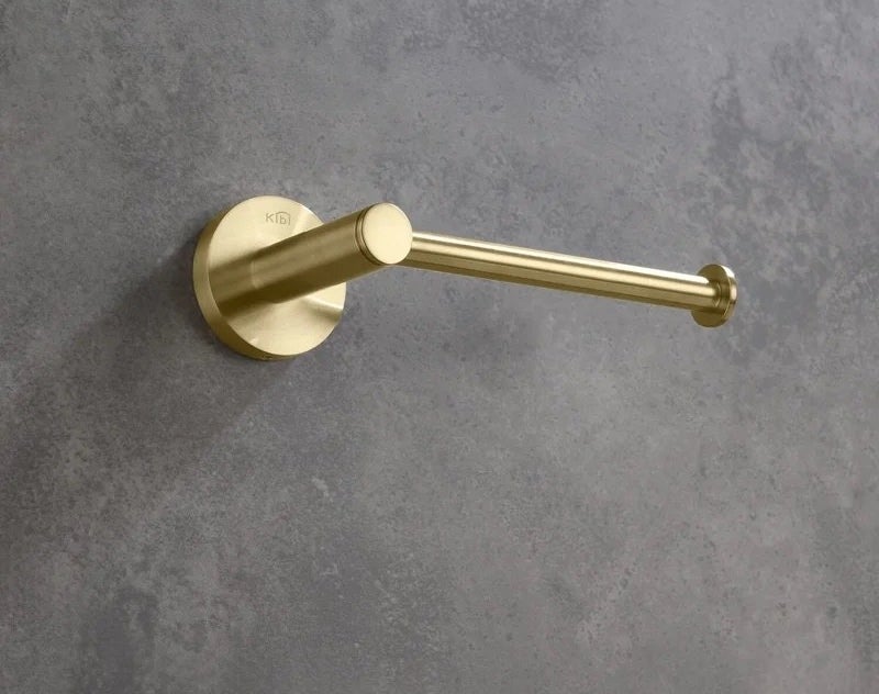 The gold wall mount toilet paper holder on a wall