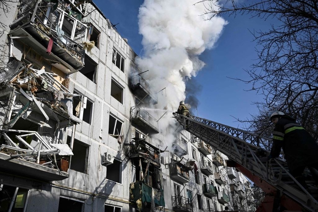 smoke comes out of a what looks to be an apartment building in Ukraine