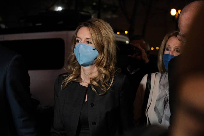 the real Elizabeth Holmes wearing a mask outside