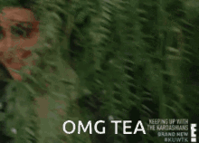 Kim coming from a hiding spot. The words &quot;OMG TEA&quot; is written in the bottom