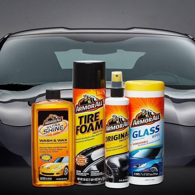 the yellow and orange car care products in front of a black car