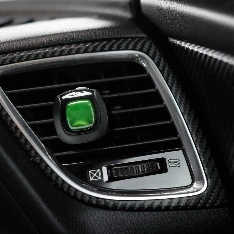 the green and black scent clip on a car vent