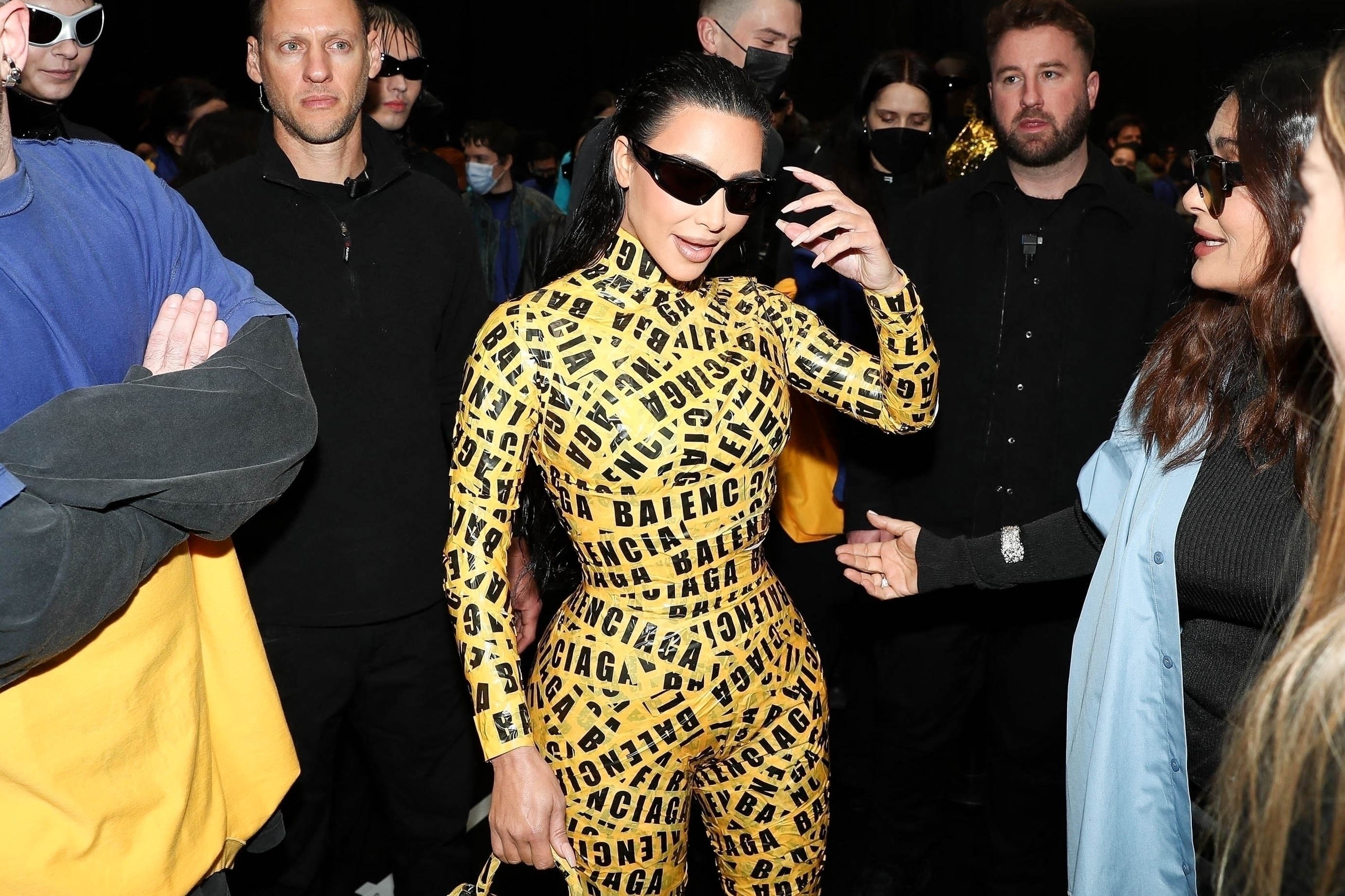 Kim Kardashian Attends Balenciaga Show in Yellow Caution Tape Catsuit