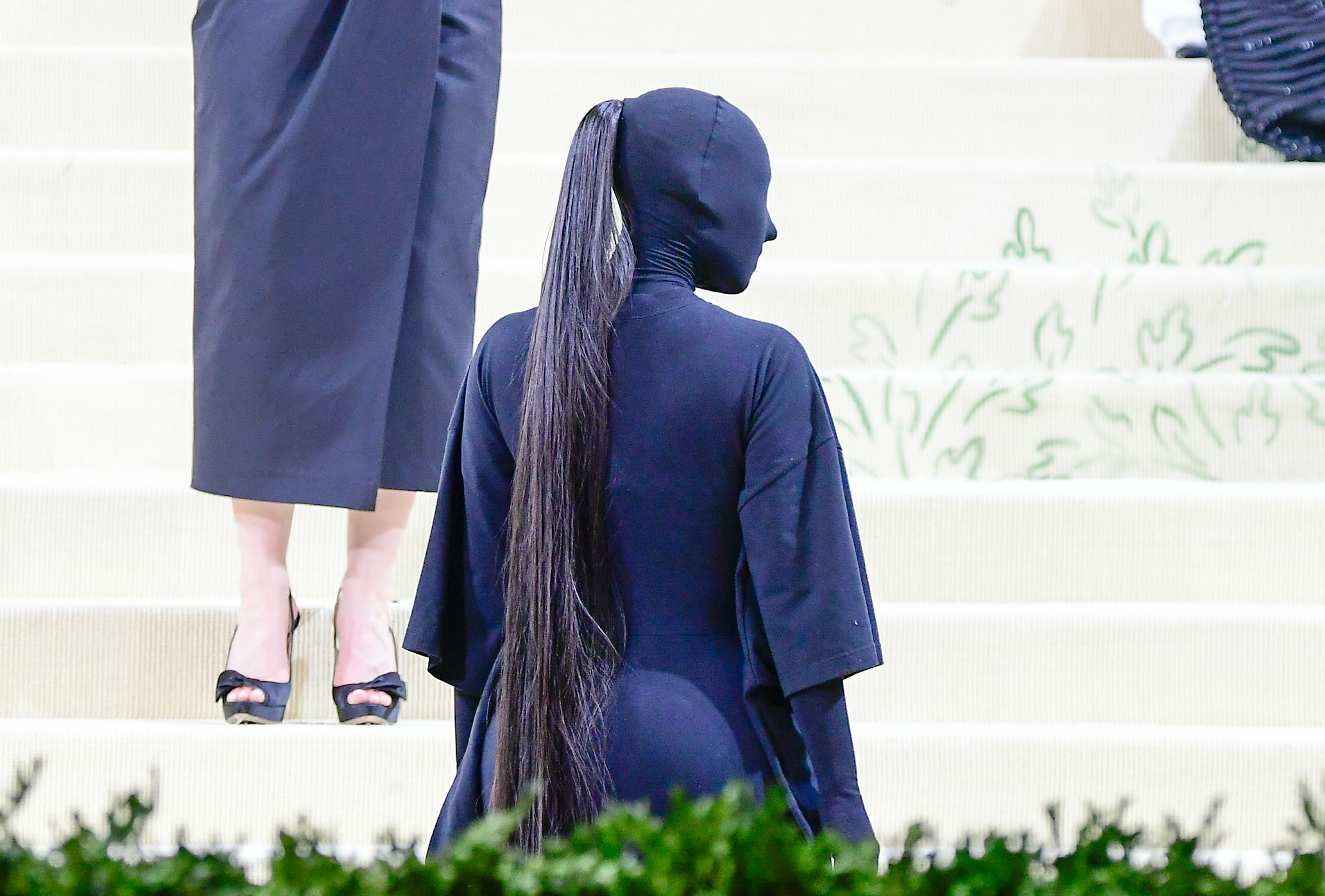 Kim wears the Met Gala bodysuit with her ponytail coming through the stocking