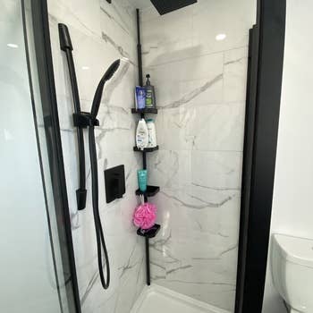 Different review photo of shower rod in a showe