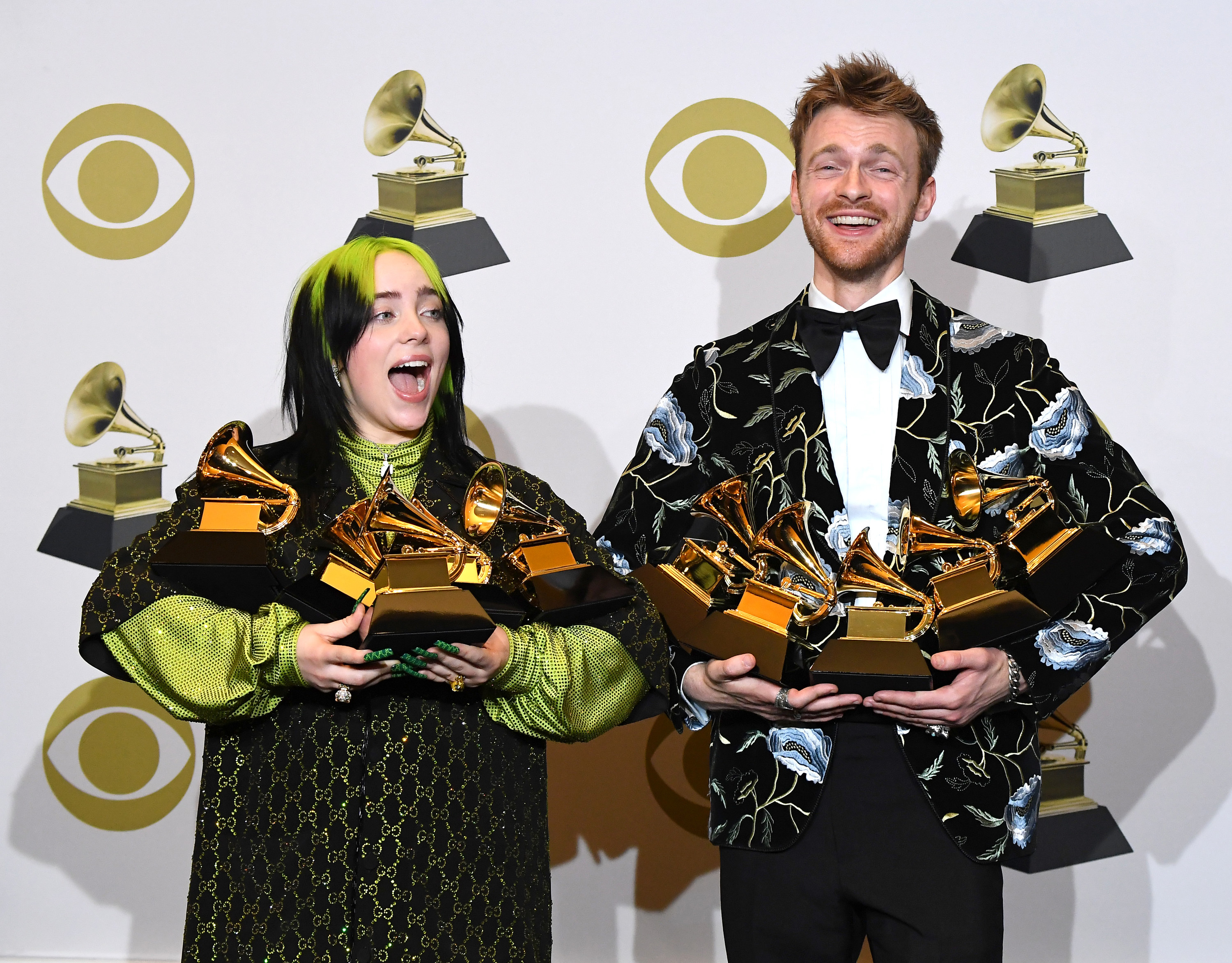 Billie and her brother and collaborator carrying their boatload of Grammys