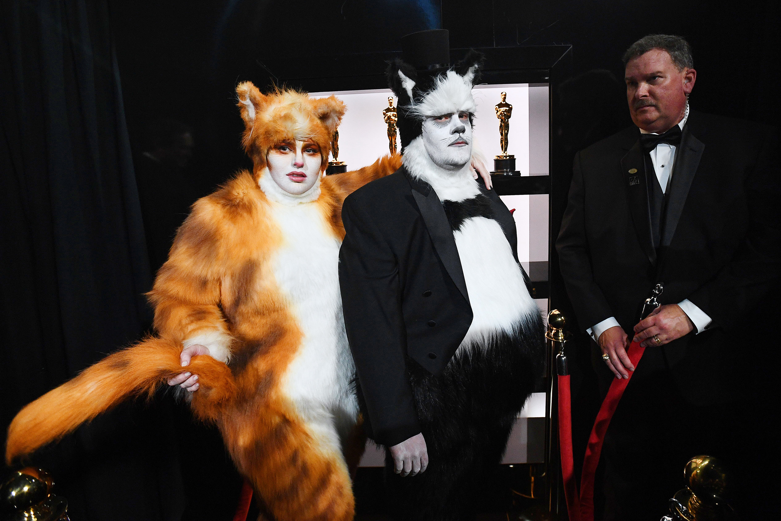 Two people dressed as cats from the film at the Oscars
