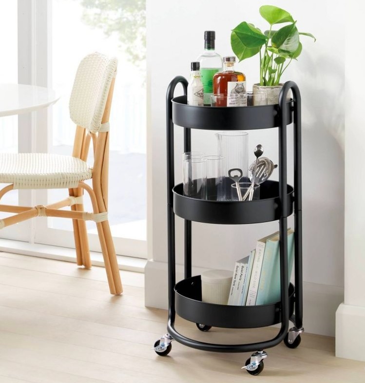 Black cart being used as a bar cart