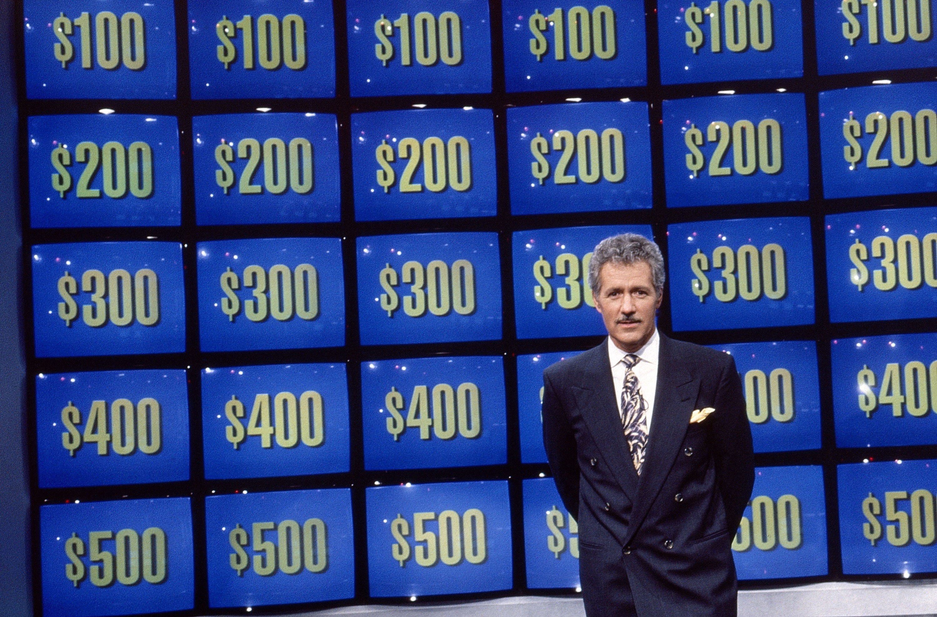 Alex Trebek in front of the game board