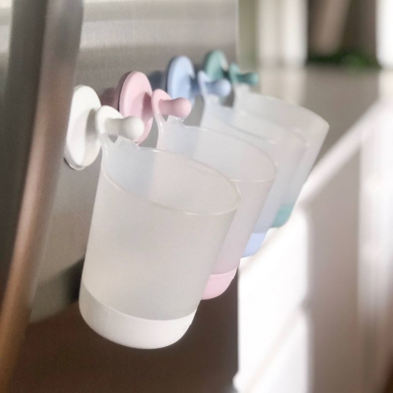 baby cups attached to a refrigerator