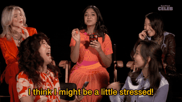 A gif of Sandra Oh laughing with the cast as Maitreyi says, &quot;I think I might be a little stressed&quot;