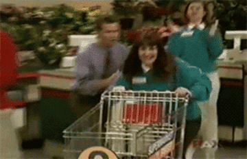gif of woman running with a shopping carriage on super market sweep