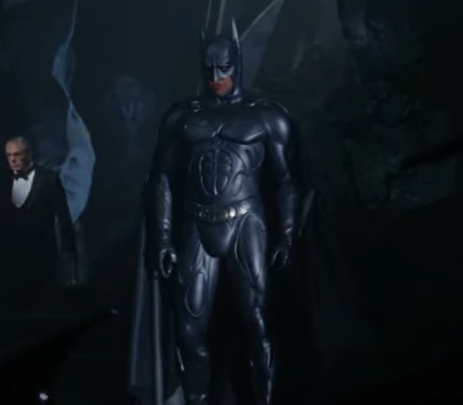Val Kilmer donning the Sonar Batsuit that is a matte dark grey suit