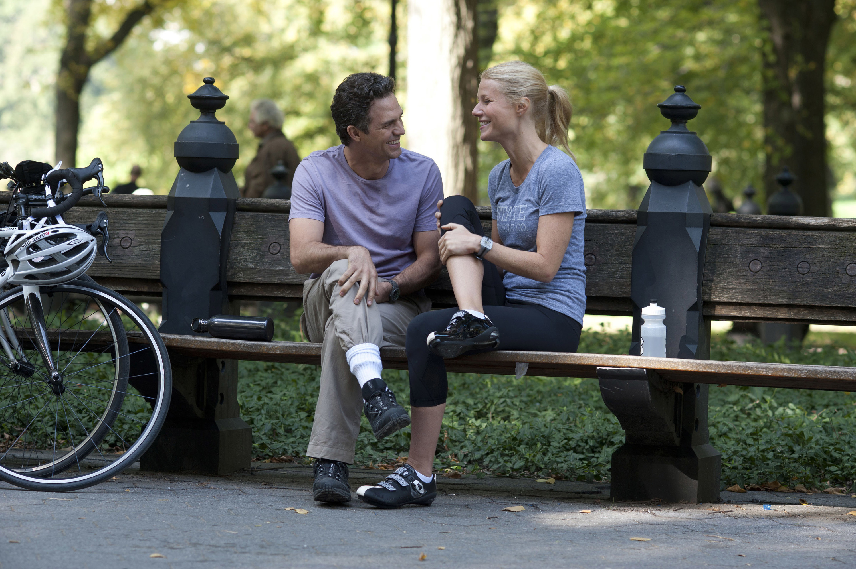 sitting on a park bench together, Mark and Phoebe are all smiles