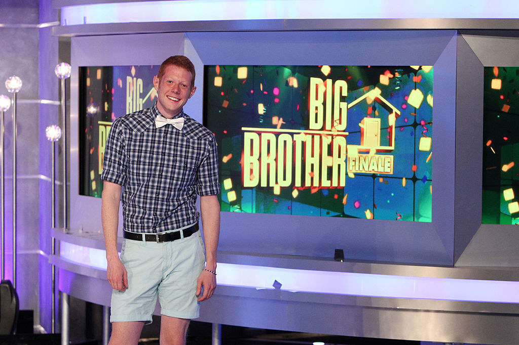 Andy Herren standing next to a screen reading &quot;Big Brother finale&quot;