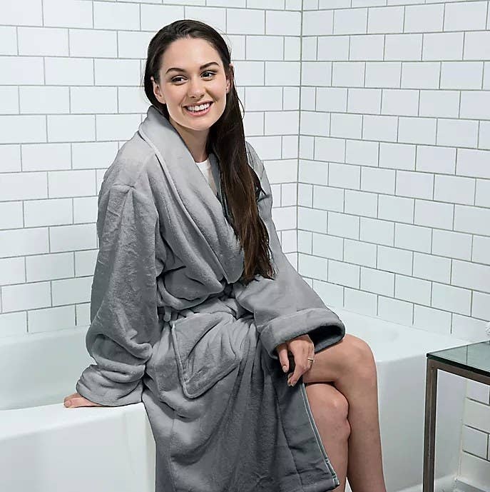 An image of a model wearing a unisex plush robe