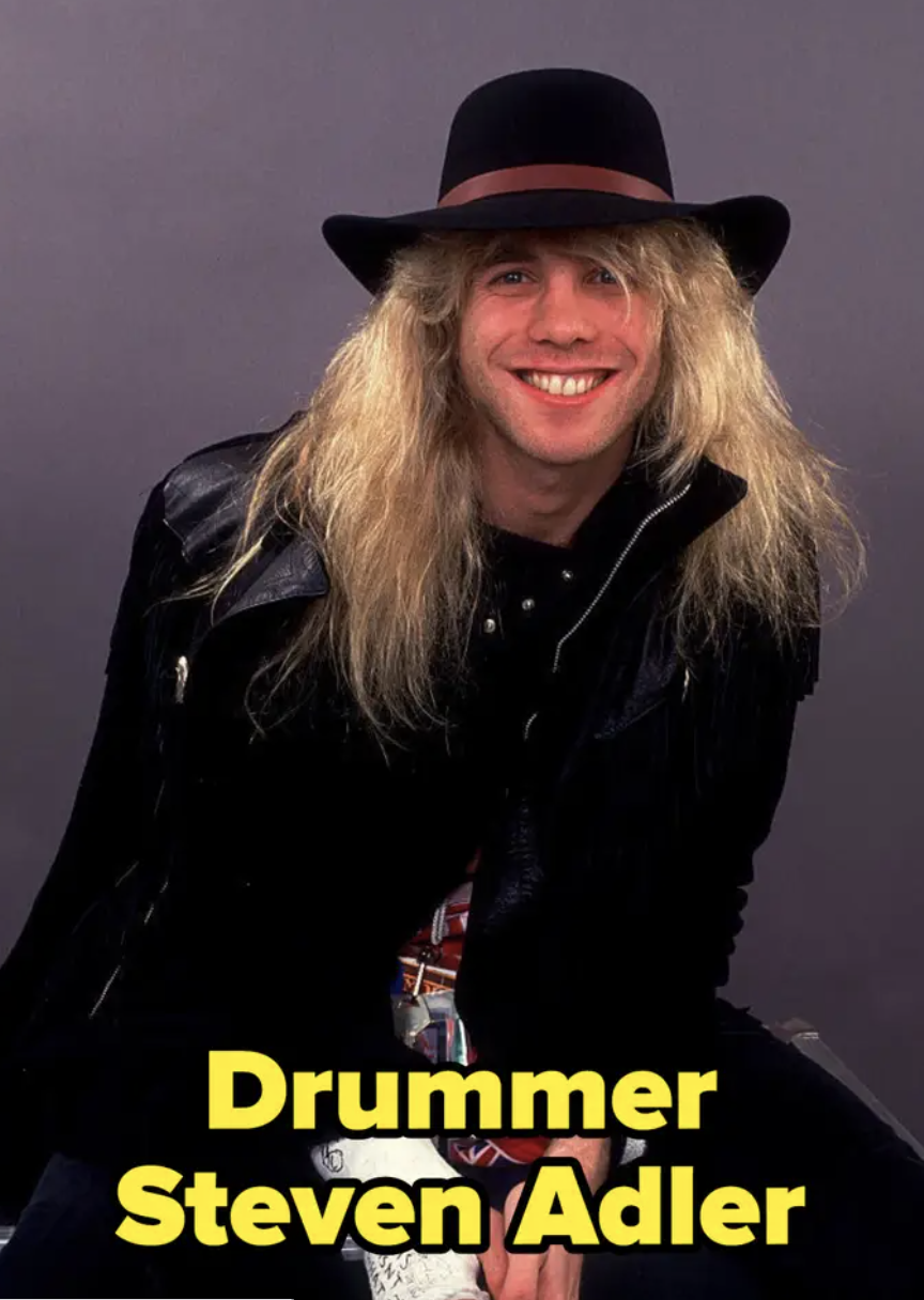 Drummer Steven Adler poses in a large-brimmed hat