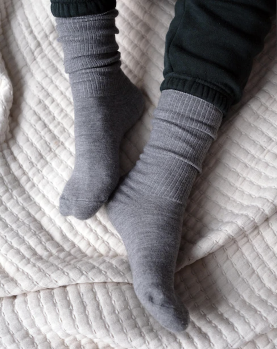 a person wearing the cashmere socks while snuggling in bed