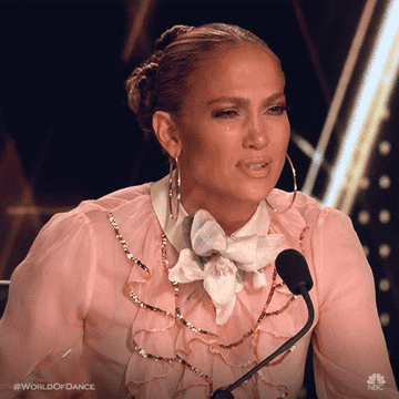 Shocked J.Lo scooting back and wrinkling her nose