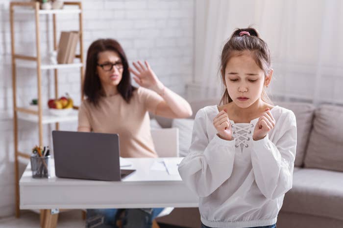 Mom yelling at their daughter while she&#x27;s working on the computer