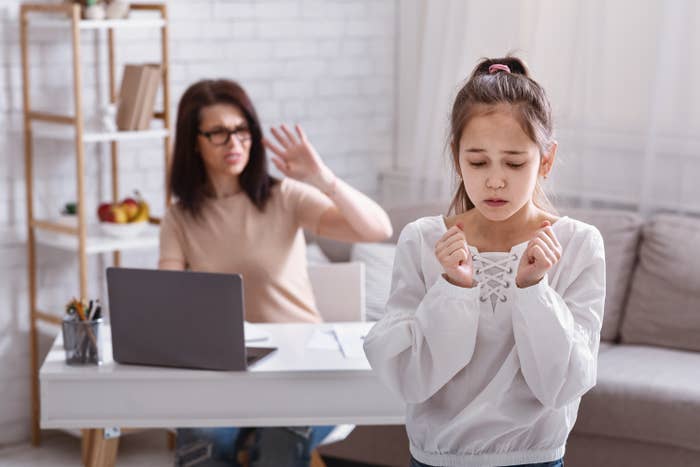 Mom yelling at their daughter while she's working on the computer