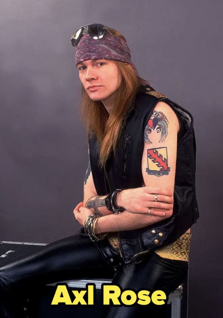 Axl Rose poses in a leather vest and pants
