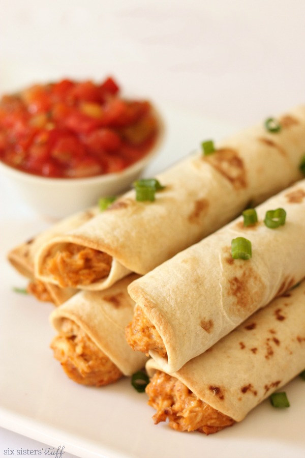 Cheesy chicken taquitos on a plate.