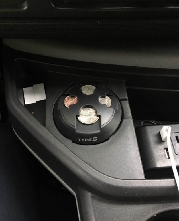 reviewer photo of the change organizer holding coins in a car