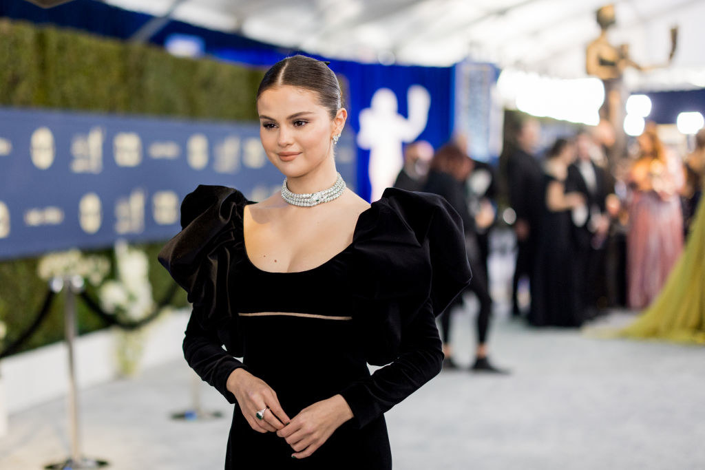 Selena Gomez wearing a black dress with puffed sleeves on the red carpet at an event