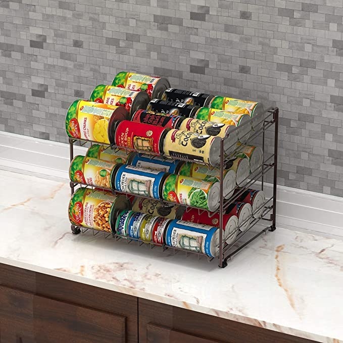 The can organizer full off different cans on a counter in a kitchen