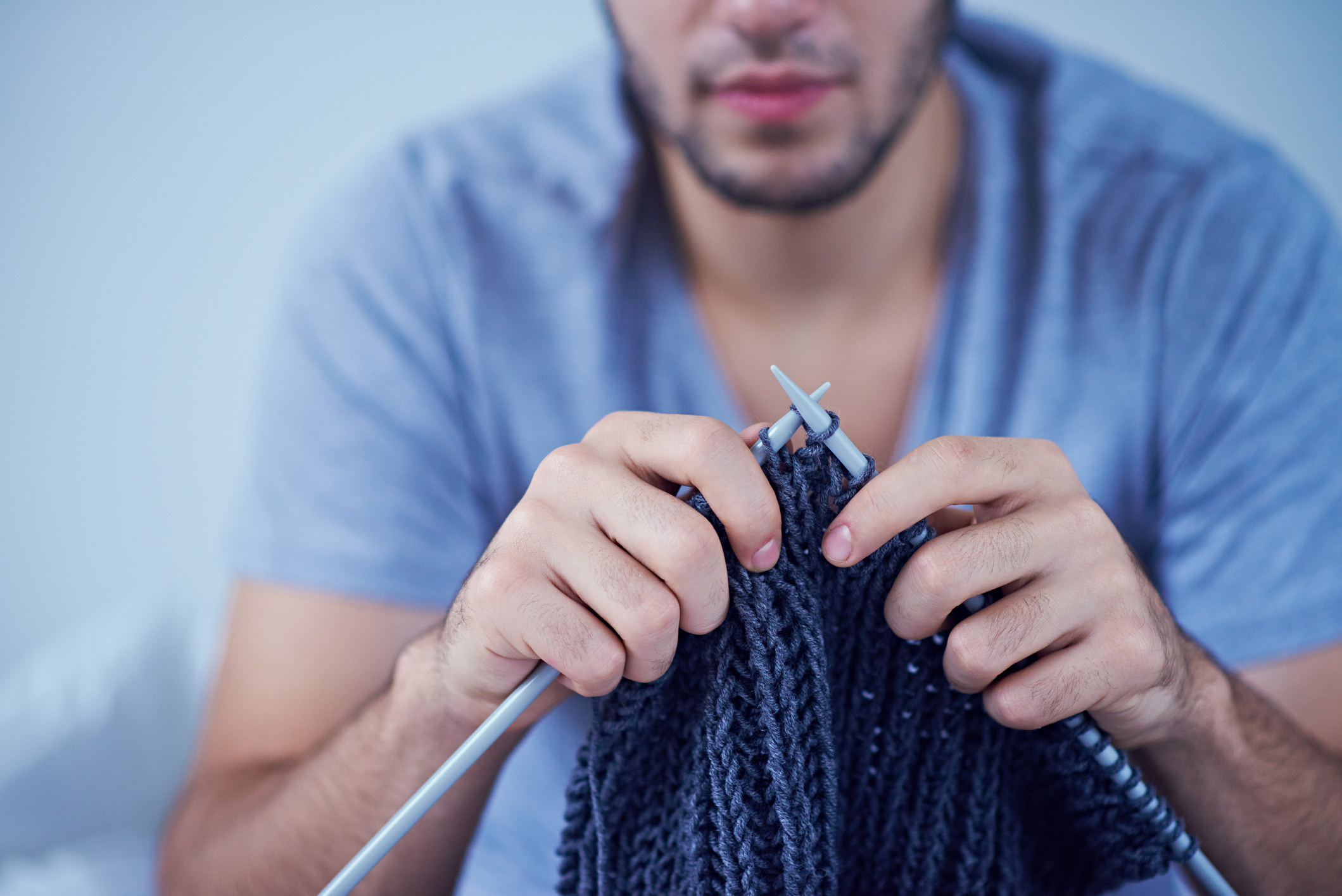 Close-up of man knitting