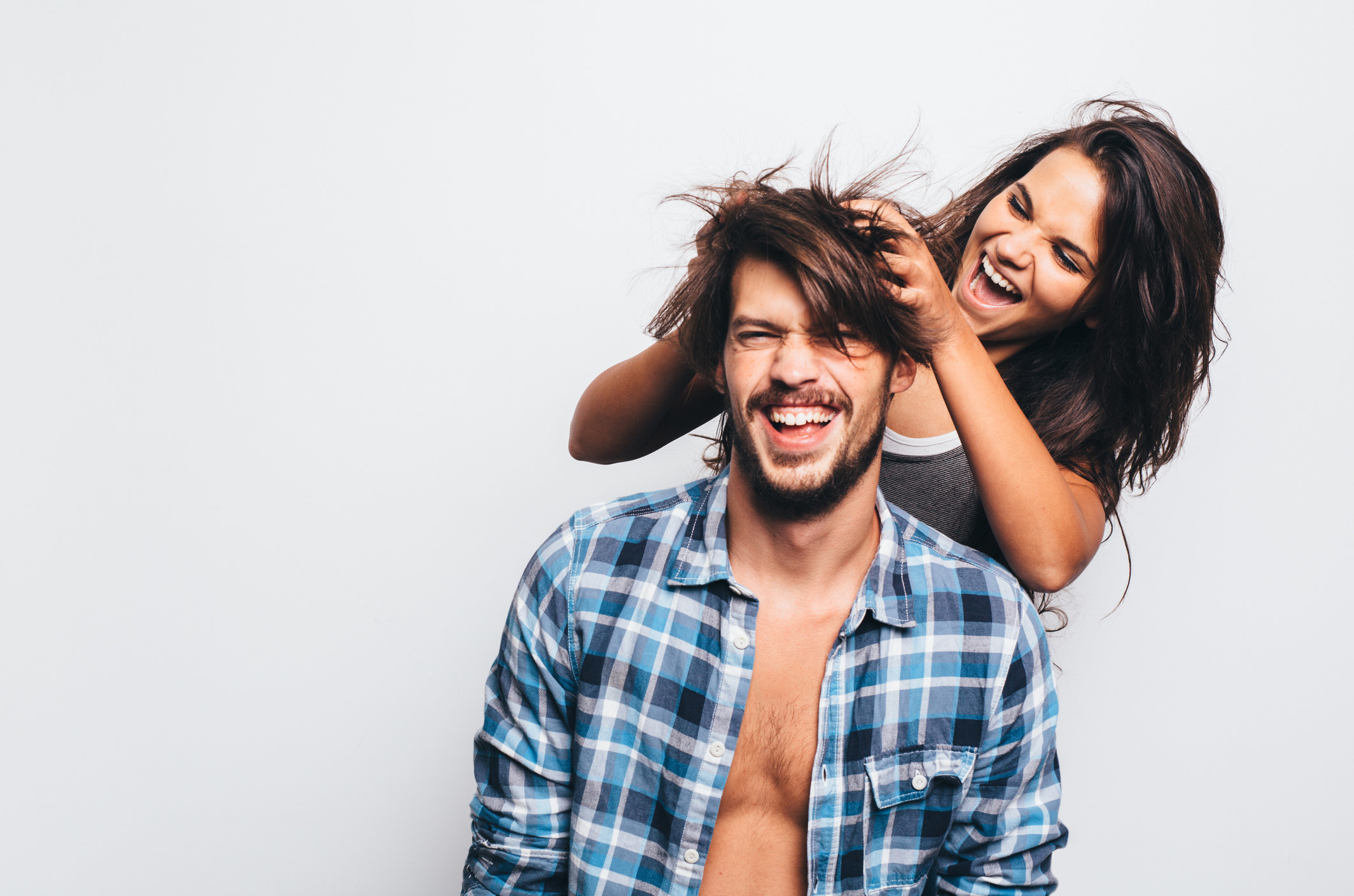 Woman playing with man&#x27;s hair
