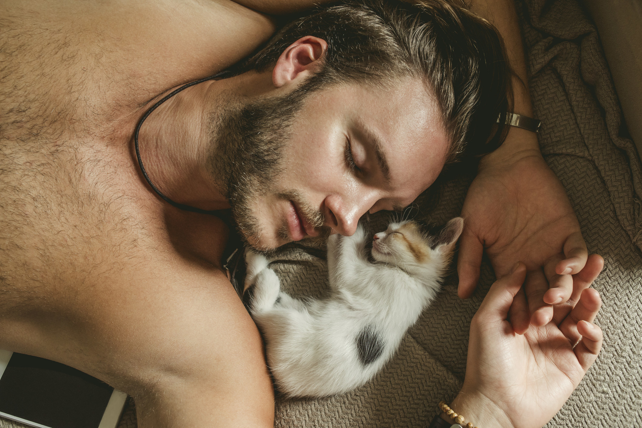 Man and his kitten napping