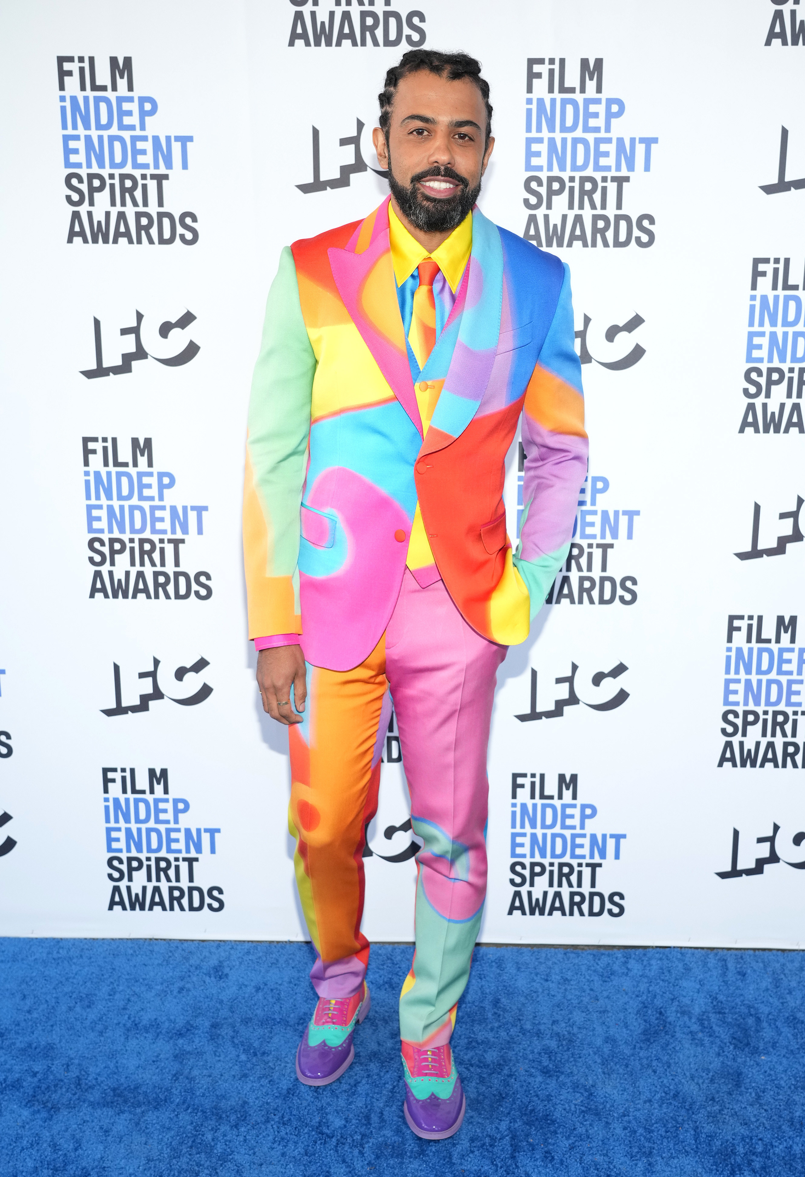 Daveed wears a suit with random splatters of pastel colors