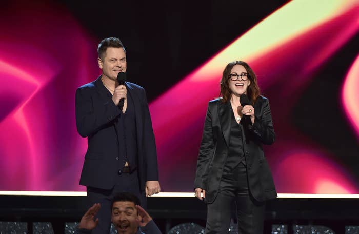 Hosts Megan Mullally and Nick Offerman stand on stage