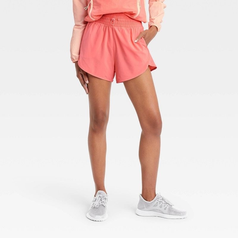 Model wearing the rose pink high-rise drawstring shorts