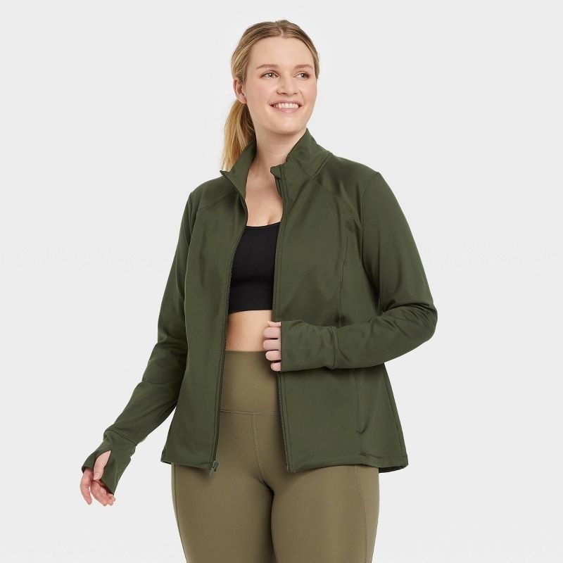 Model wearing the olive green zip-front jacket