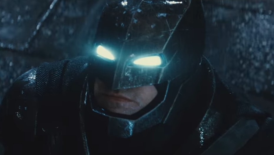 Ben Affleck donning the armored Batsuit looking up at the sky while its raining