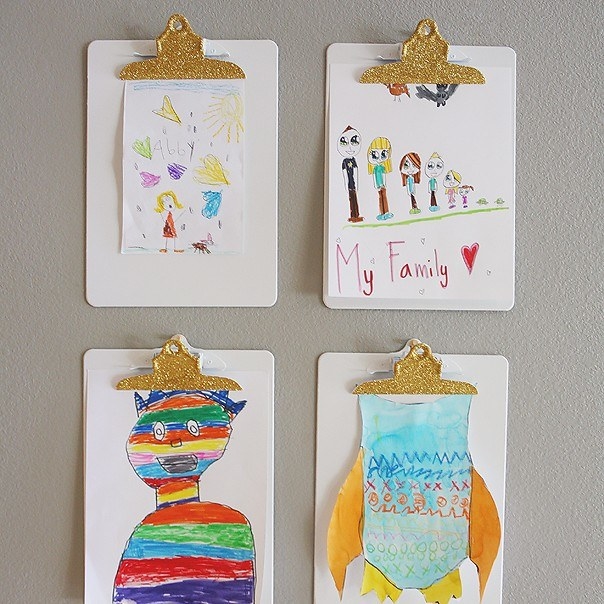 Blogger&#x27;s photo of their kids&#x27; artwork displayed on four clipboards on the wall