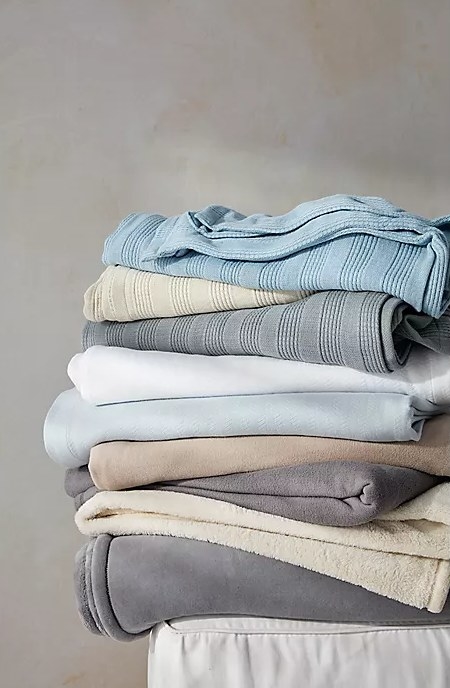 An image of a plush blanket alongside other bedroom linens