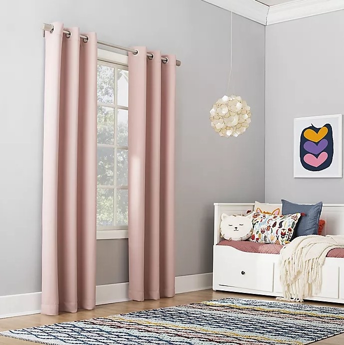 An image of two kids window curtain panels inside a bedroom