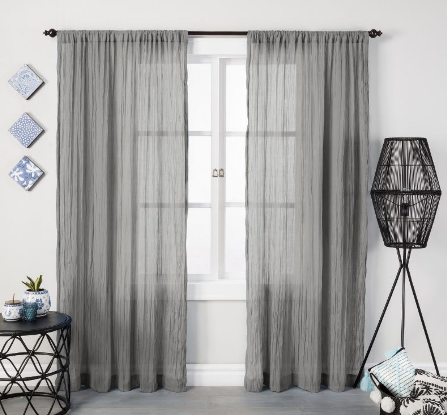 Two grey curtain panels framing a window