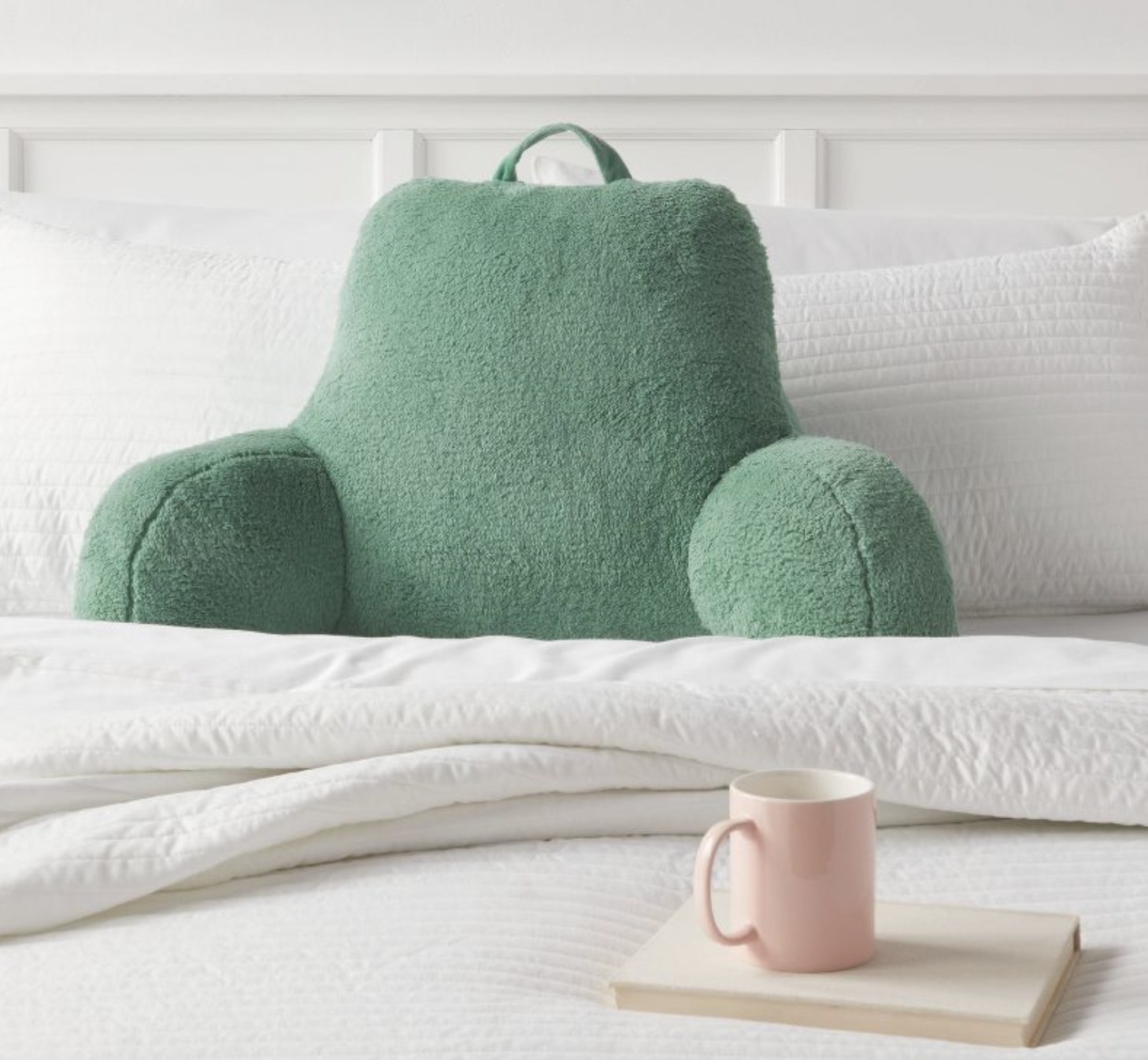 The green pillow on a bed