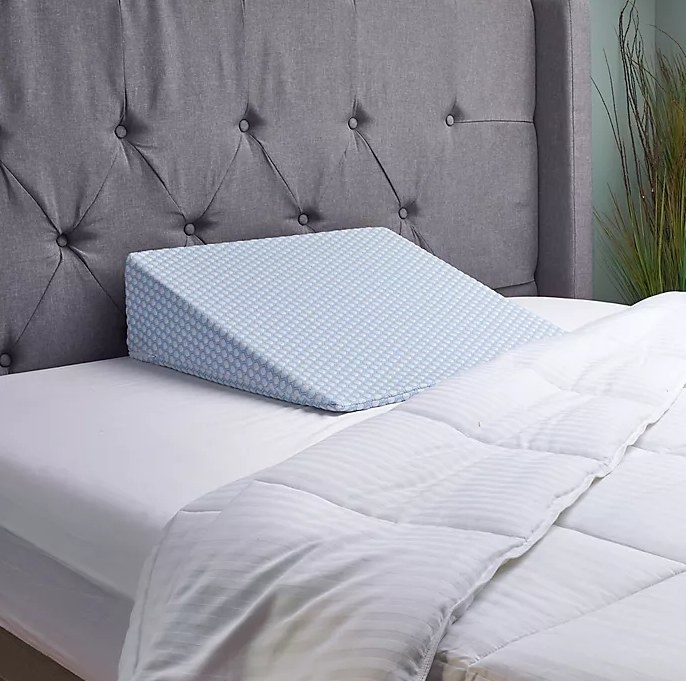 An image of a wedge support pillow on top of a bed